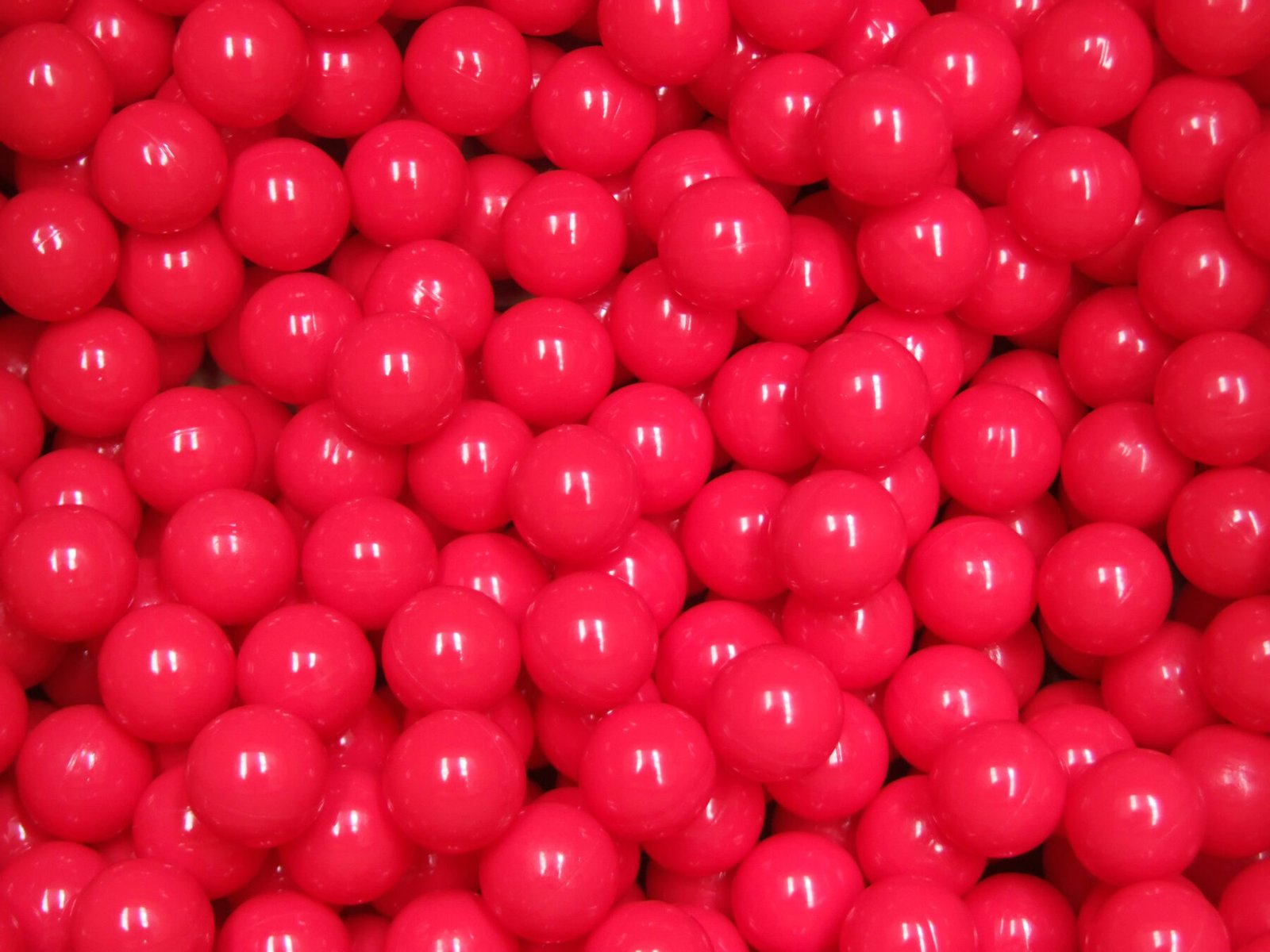 A dense field of glossy red .68 caliber paintballs